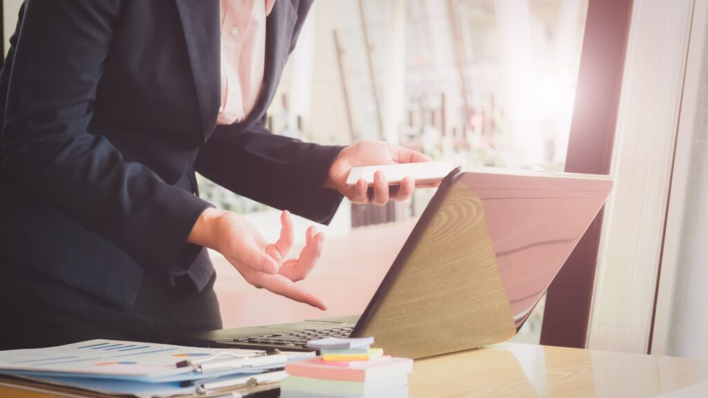 Professional Tax Software Reviews — reviewing documents on a tablet in the office