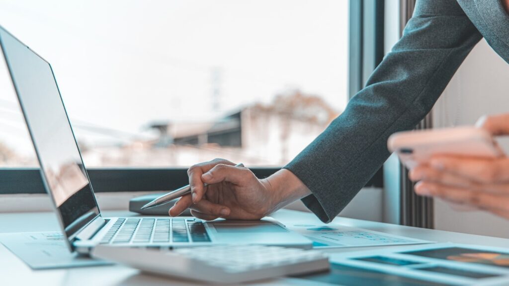 Ptin Application — reviewing documents on a laptop at a work table