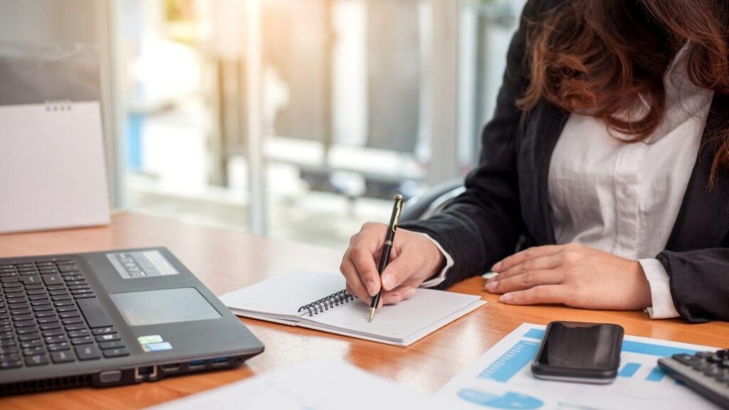 No Efin Tax Software — writing notes next to a laptop with charts